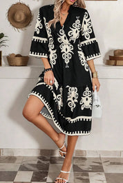 Black and white floral print half-sleeve knee-length dress with V-neck and side slits