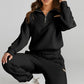 Daverri black quarter zip sweatshirt with gold zipper and chest cutout