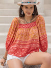 Vibrant coral and gold bohemian Daverri printed square neck balloon sleeve blouse
