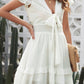 White ruffled short-sleeved tie-front mini dress with smocked waist
