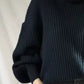 Black ribbed knit oversized turtleneck sweater with voluminous sleeves