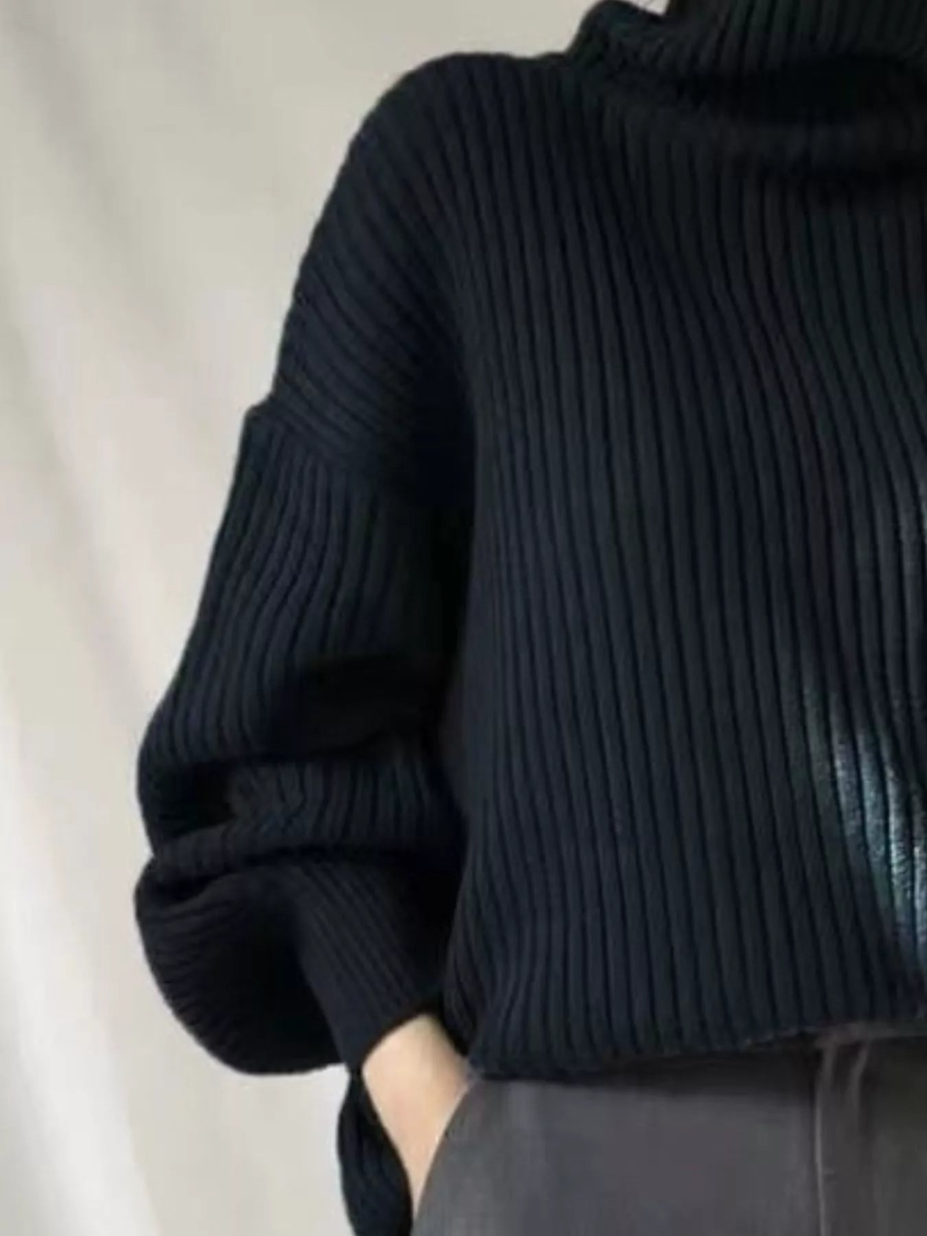 Black ribbed knit oversized turtleneck sweater with voluminous sleeves