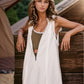 White sleeveless half-zipped hooded romper vest dress with frayed hem, olive inner top
