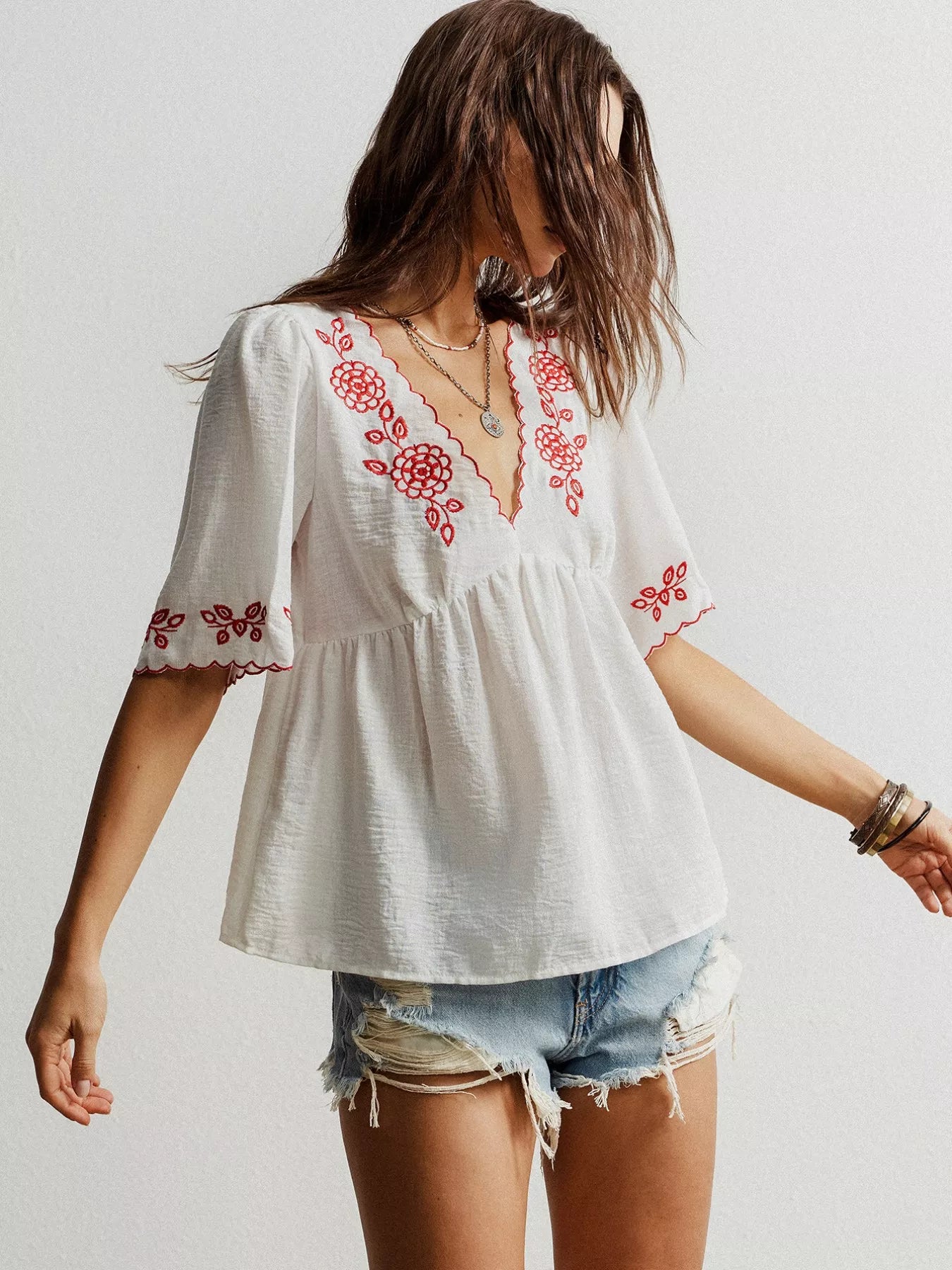White embroidered floral V-neck blouse with red details