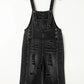 Distressed wide strap denim overalls in black with wide legs and buttoned straps