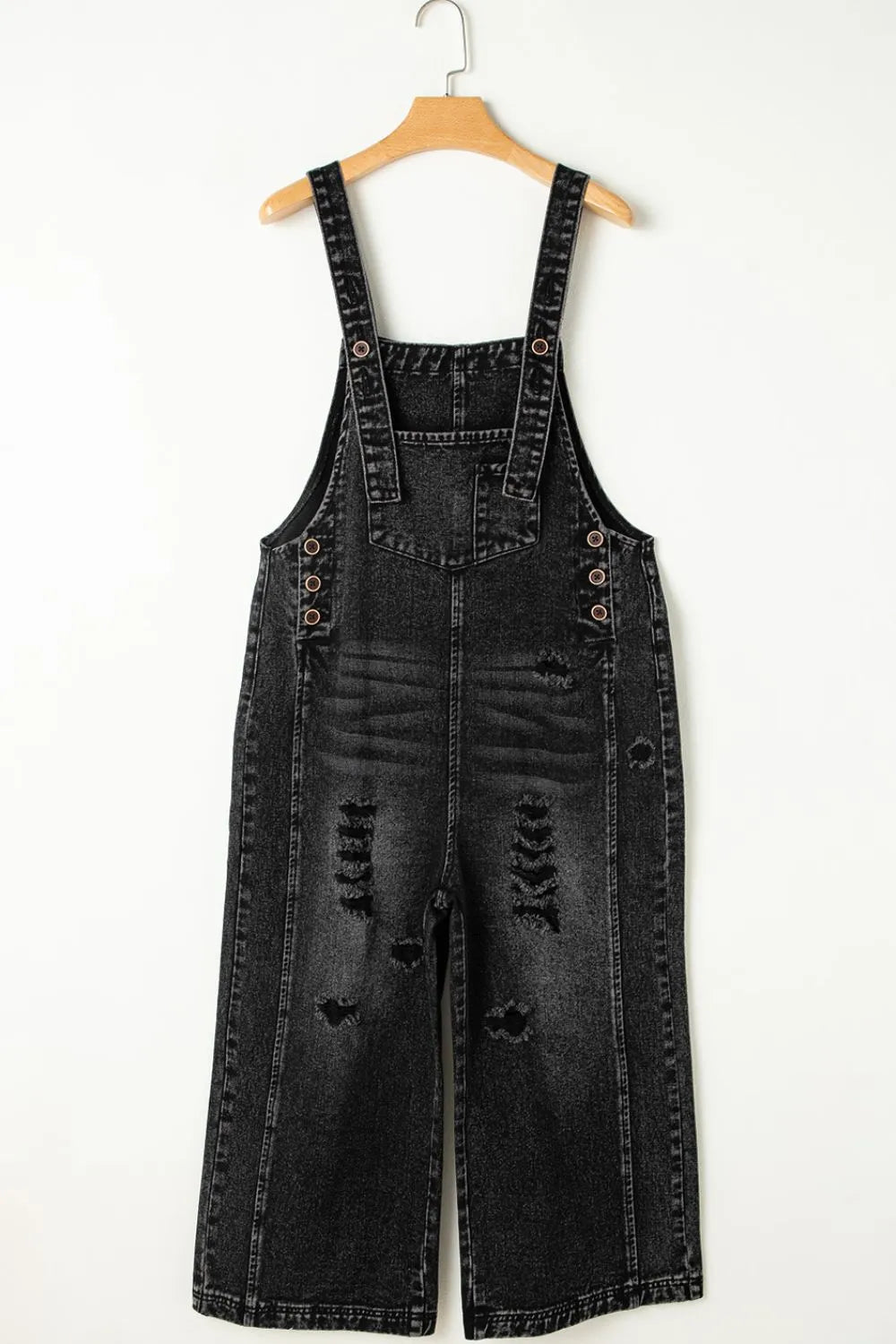 Distressed wide strap denim overalls in black with wide legs and buttoned straps