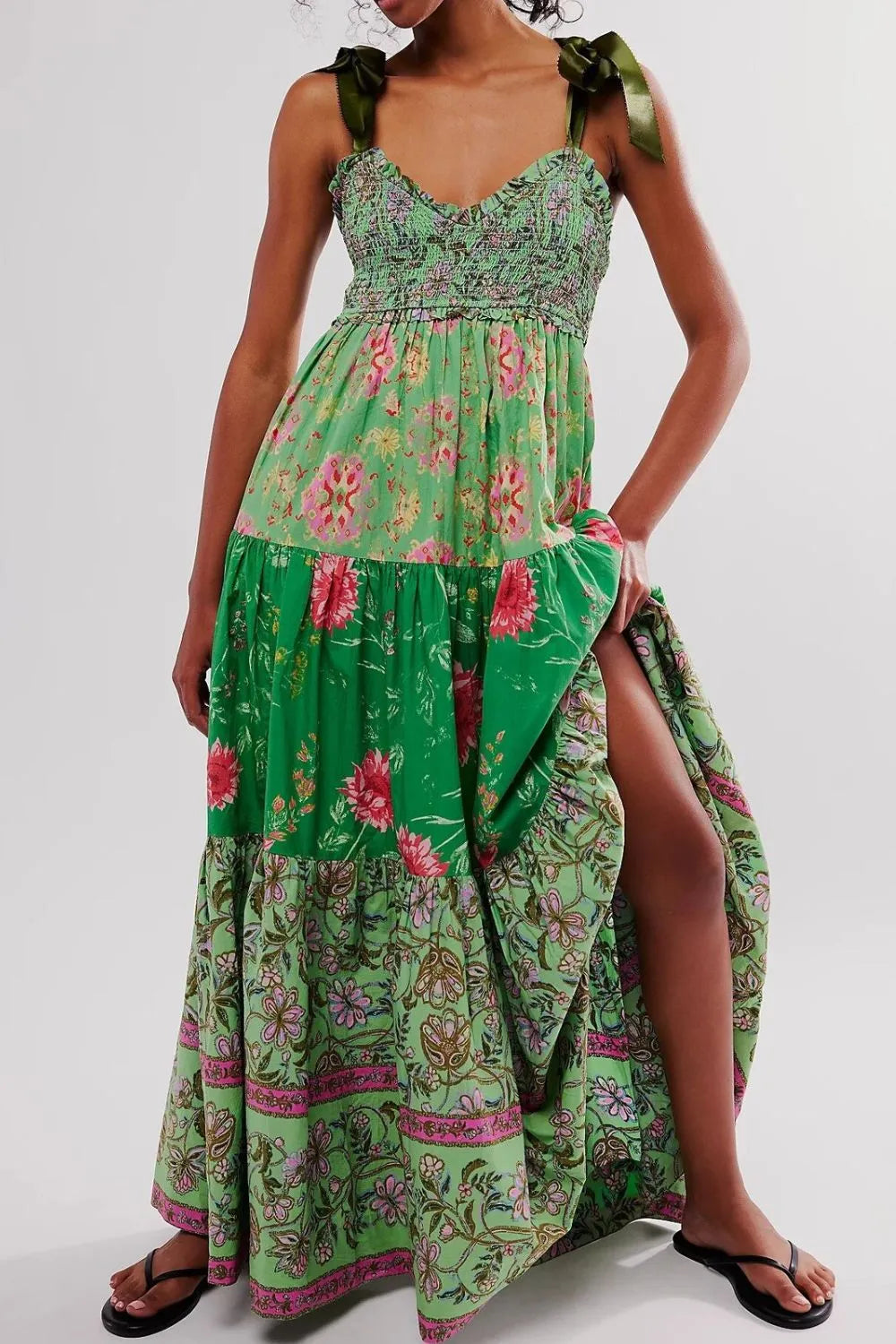 Floral tiered maxi dress in green with pink beige blossoms, smocked bodice, bows, ruffles, slit