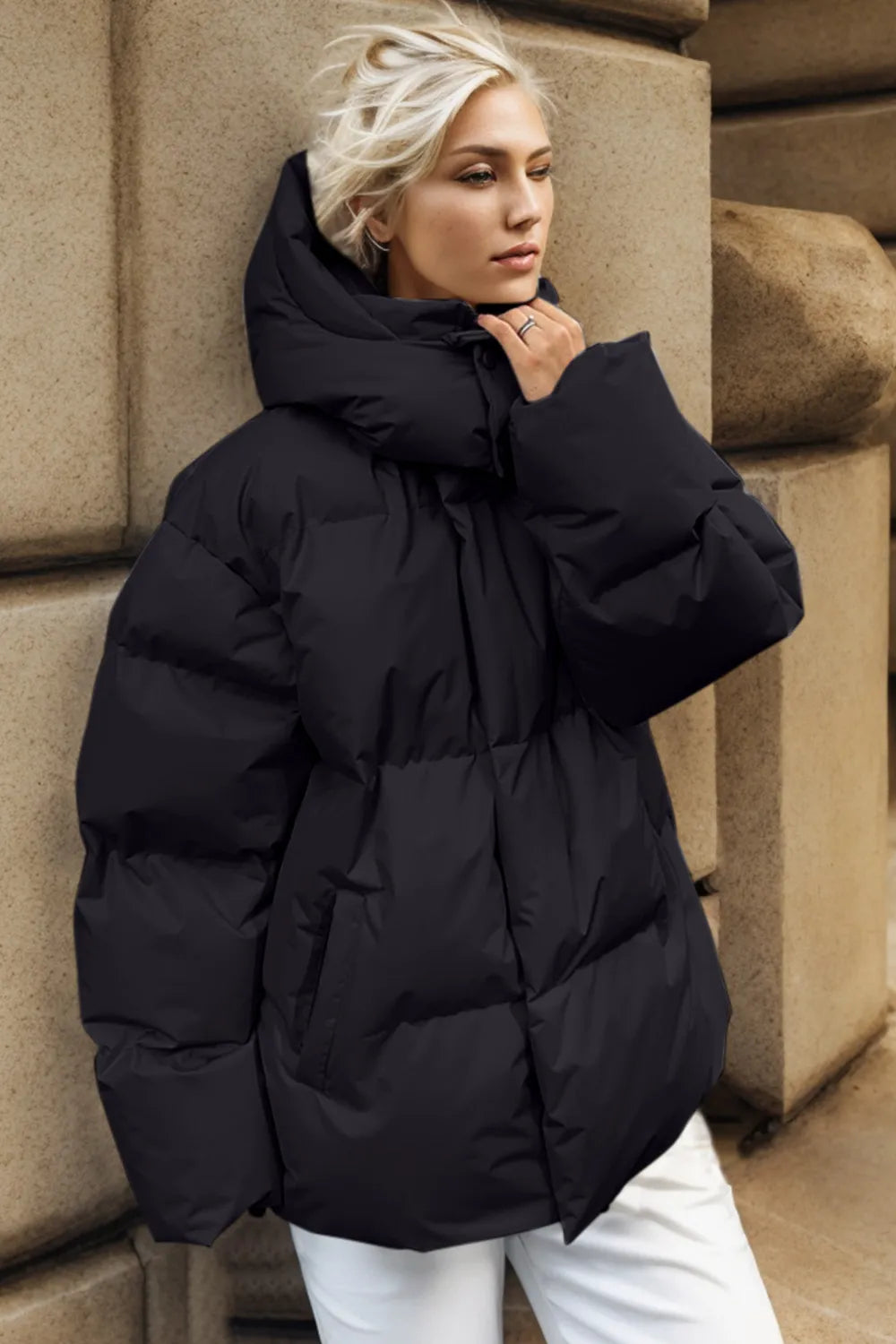 Black pocketed zip-up hooded puffer jacket with quilted design