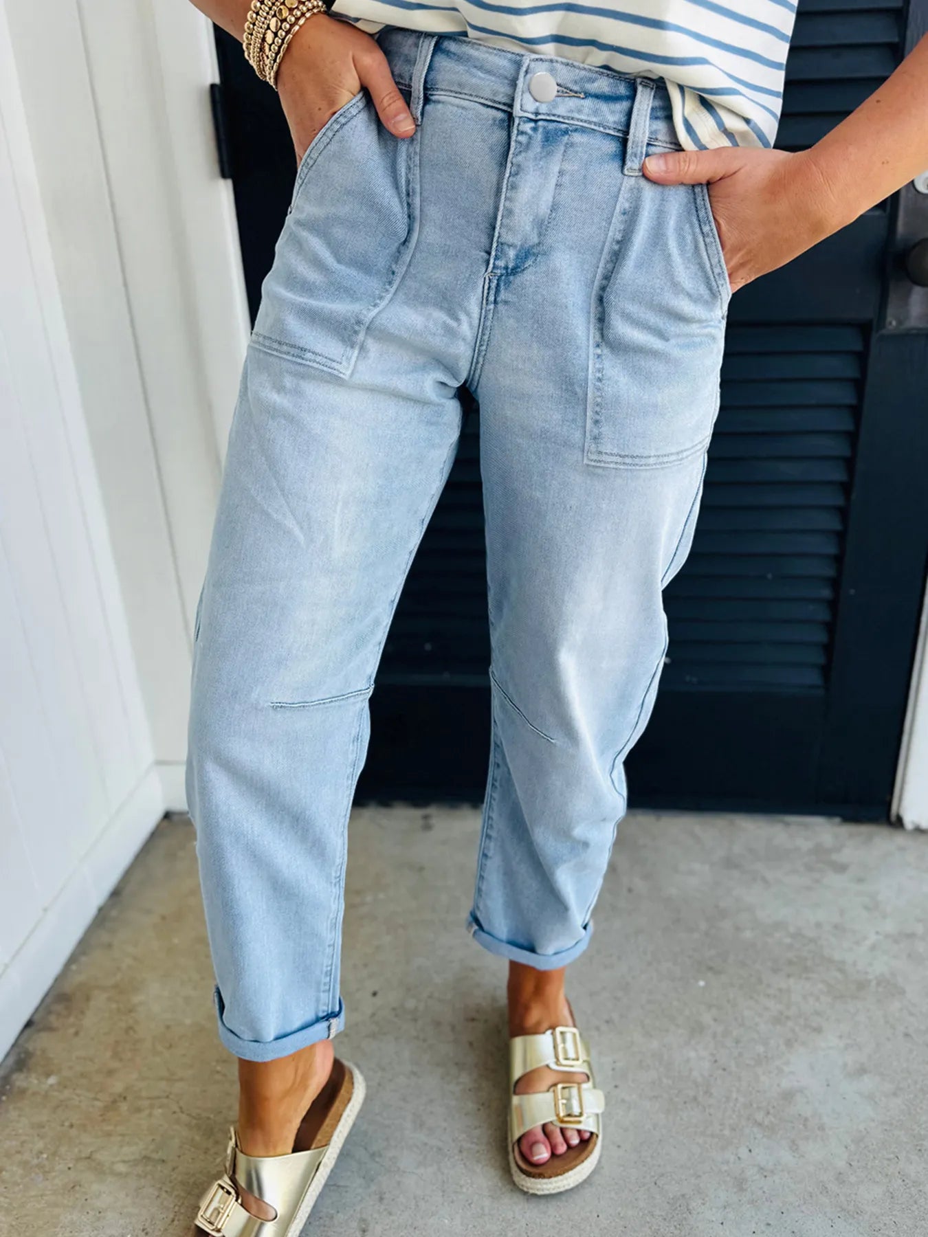 Light blue high-rise boyfriend jeans with rolled cuffs