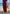 Woman in Daverri Fashions maroon V-neck maxi dress with side slit on beach