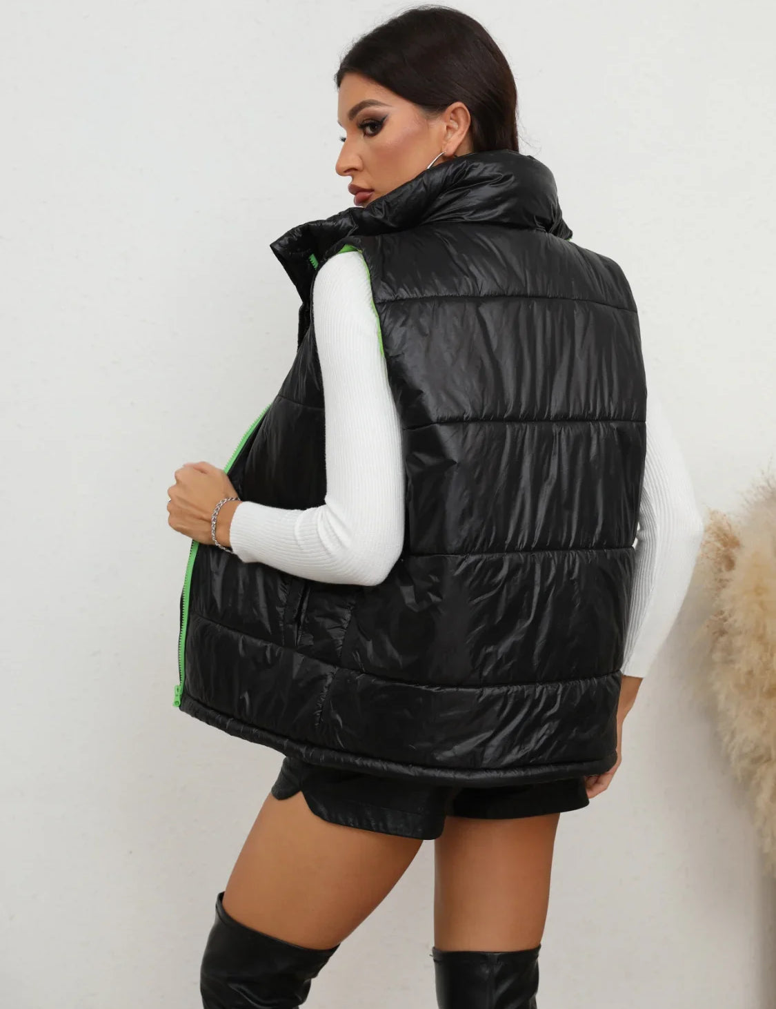 Black quilted puffer zip-up collared vest with green accents