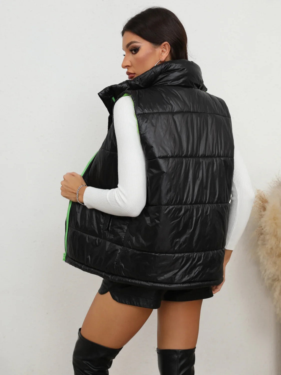 Black quilted puffer zip-up collared vest with green accents