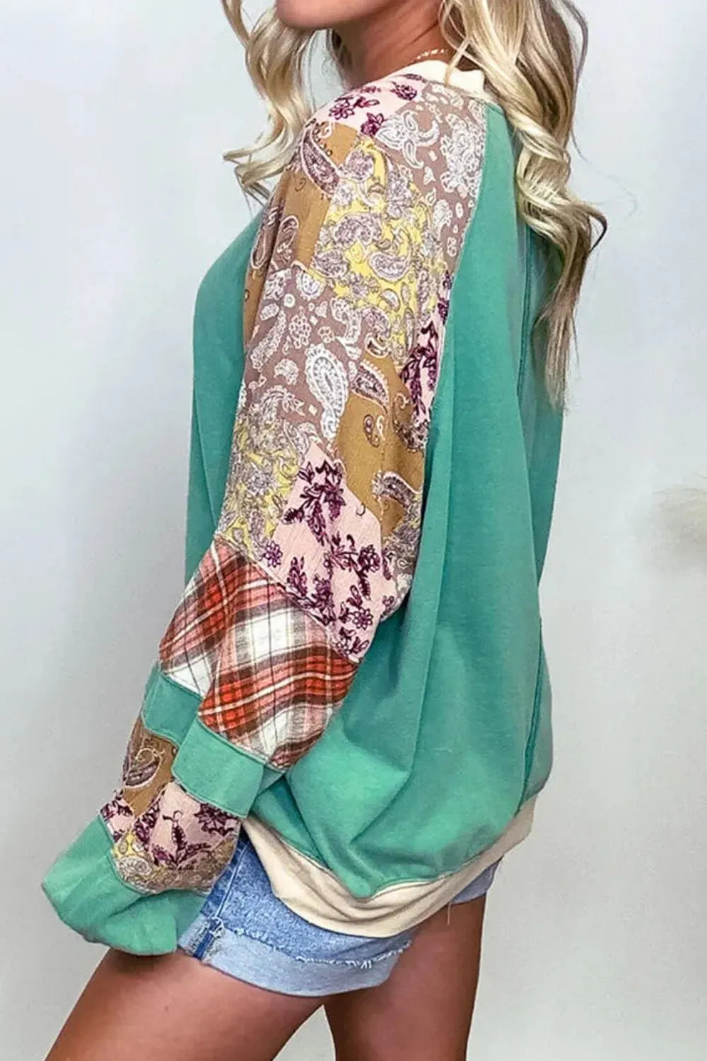 Plus size printed raglan sleeve sweatshirt in teal and beige patchwork with paisley, plaid panels