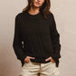 Black oversized cable-knit BiBi Twist sweater with relaxed fit