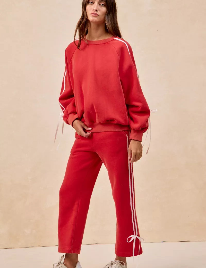 Red BiBi fleece sweatpants with white side stripes and bow details
