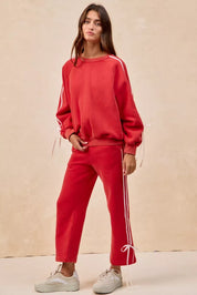 Red BiBi fleece sweatpants with white side stripes and bow details