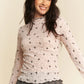 Delicate light pink Davi & Dani long-sleeve mesh top with bow pattern