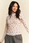 Delicate light pink Davi & Dani long-sleeve mesh top with bow pattern