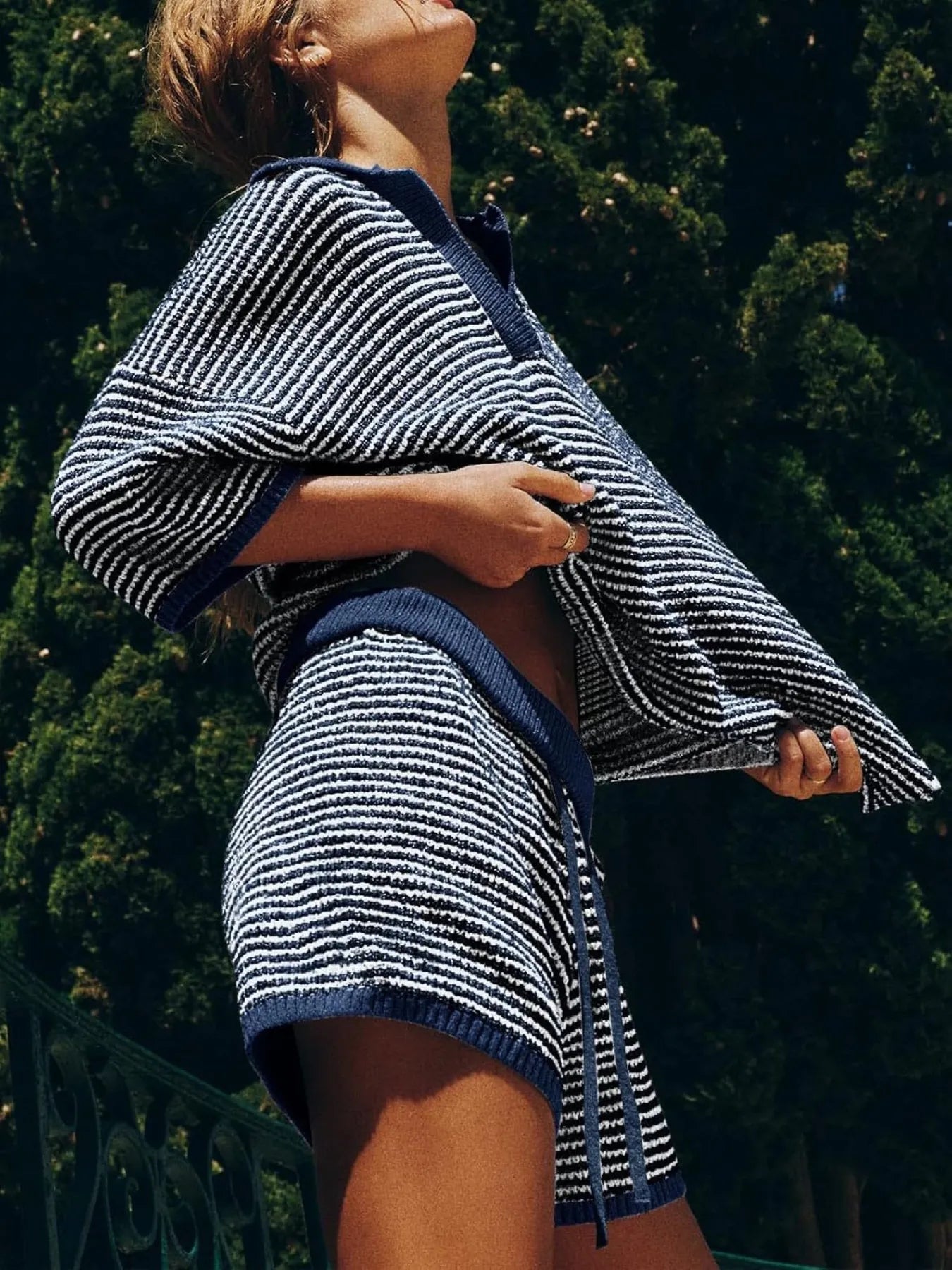 Woman in navy white striped collared loose fit top shorts sweater set
