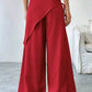 Daverri red wrap-front wide-leg pants with draped asymmetrical design