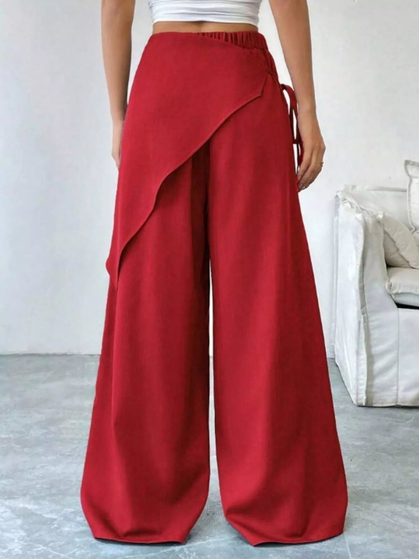 Daverri red wrap-front wide-leg pants with draped asymmetrical design