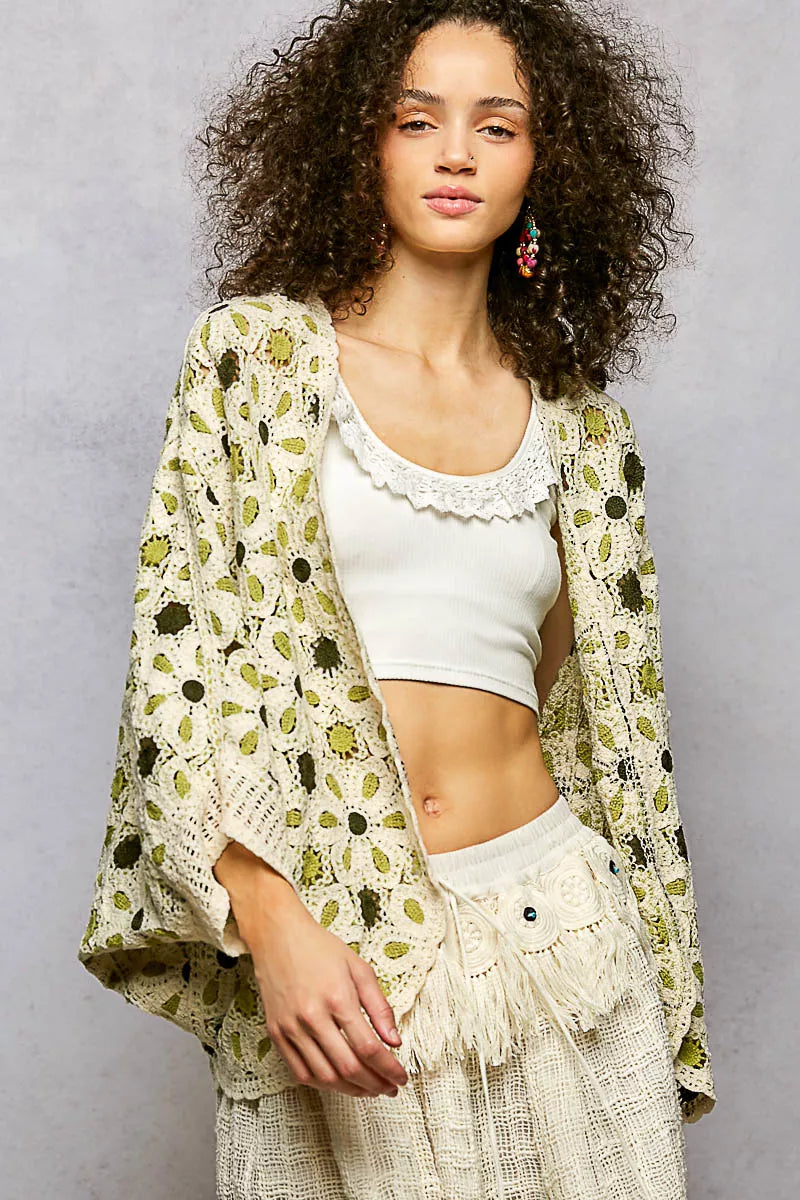Cream-colored POL open-front crochet cardigan with green-black floral pattern