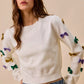White SO ME Mardi Gras knit sweater with colorful sequined bows