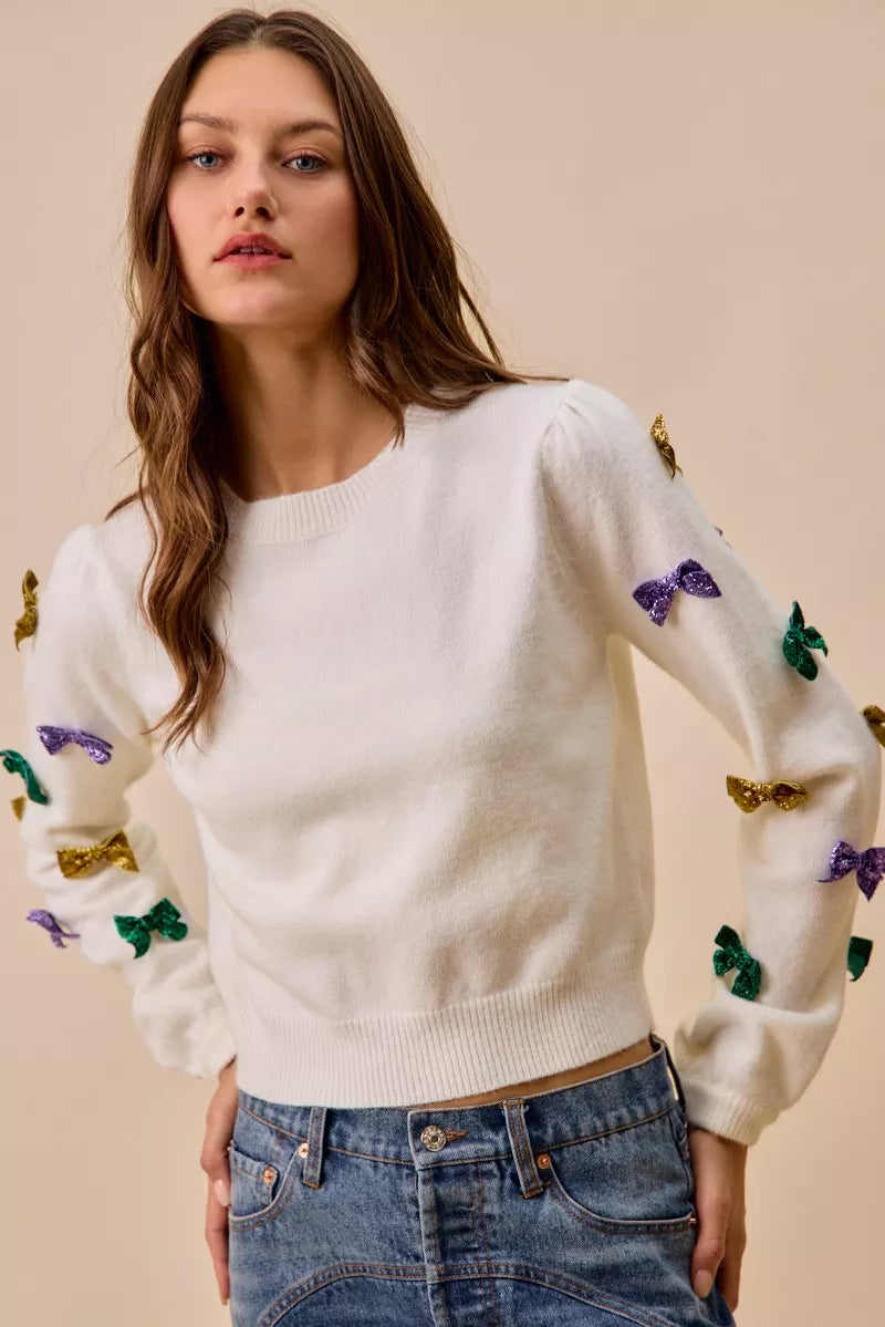 White SO ME Mardi Gras knit sweater with colorful sequined bows