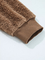 Brown fuzzy zip-up hoodie with ribbed cuffs and hem