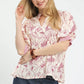 Woman in Umgee Mixed Print Puff Sleeve Split Neck Top with floral blouse