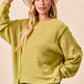 Cozy olive-green BiBi Boucle rib knit sweater with ruffled sleeves
