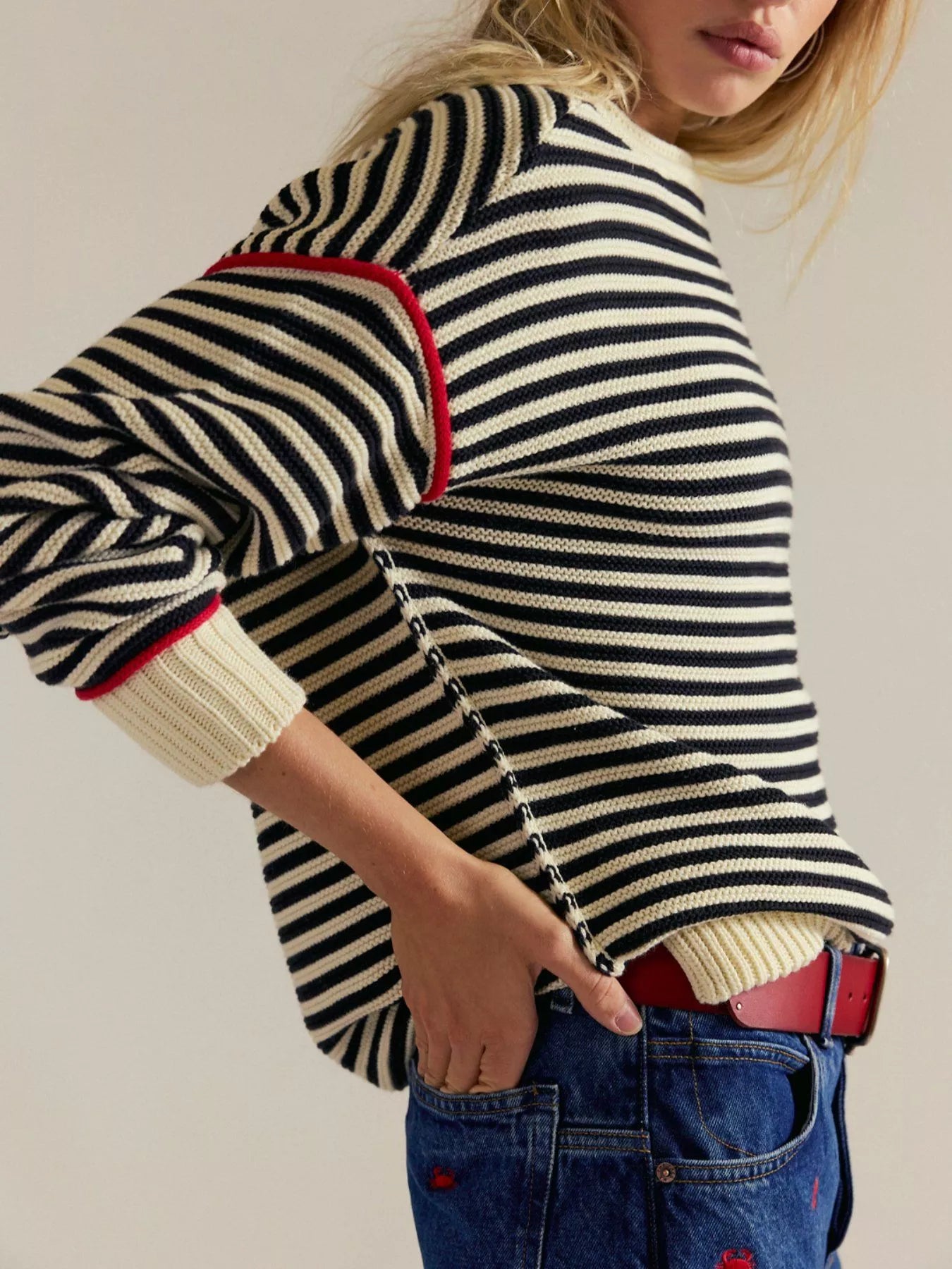 Striped round neck long sleeve sweater in black and white with red cuffs