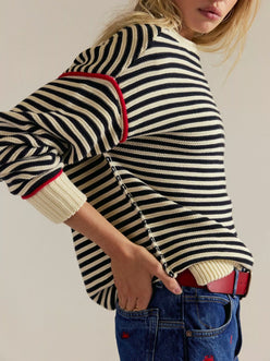 Striped round neck long sleeve sweater in black and white with red cuffs
