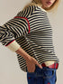 Striped round neck long sleeve sweater in black and white with red cuffs