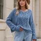 Soft blue chunky knit cable sweater with round neck and dropped shoulders