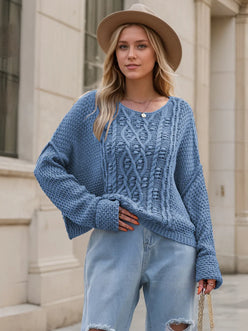 Soft blue chunky knit cable sweater with round neck and dropped shoulders