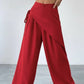 Daverri Wrap-Front Wide-Leg Pants in red with draped asymmetrical design and side tie