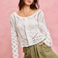White crochet cardigan with lace patterns on twill shorts