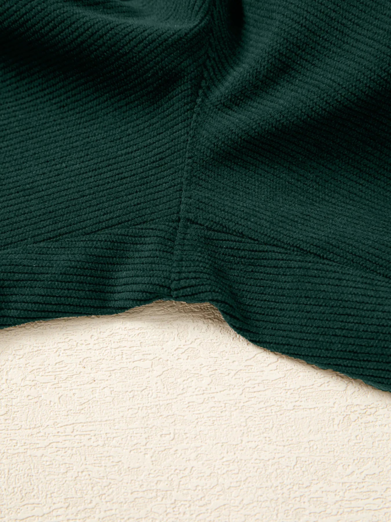 Dark green ribbed corduroy fabric for women’s V-neck sleeveless jumpsuit