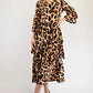Woman wearing a leopard print dress on a white background