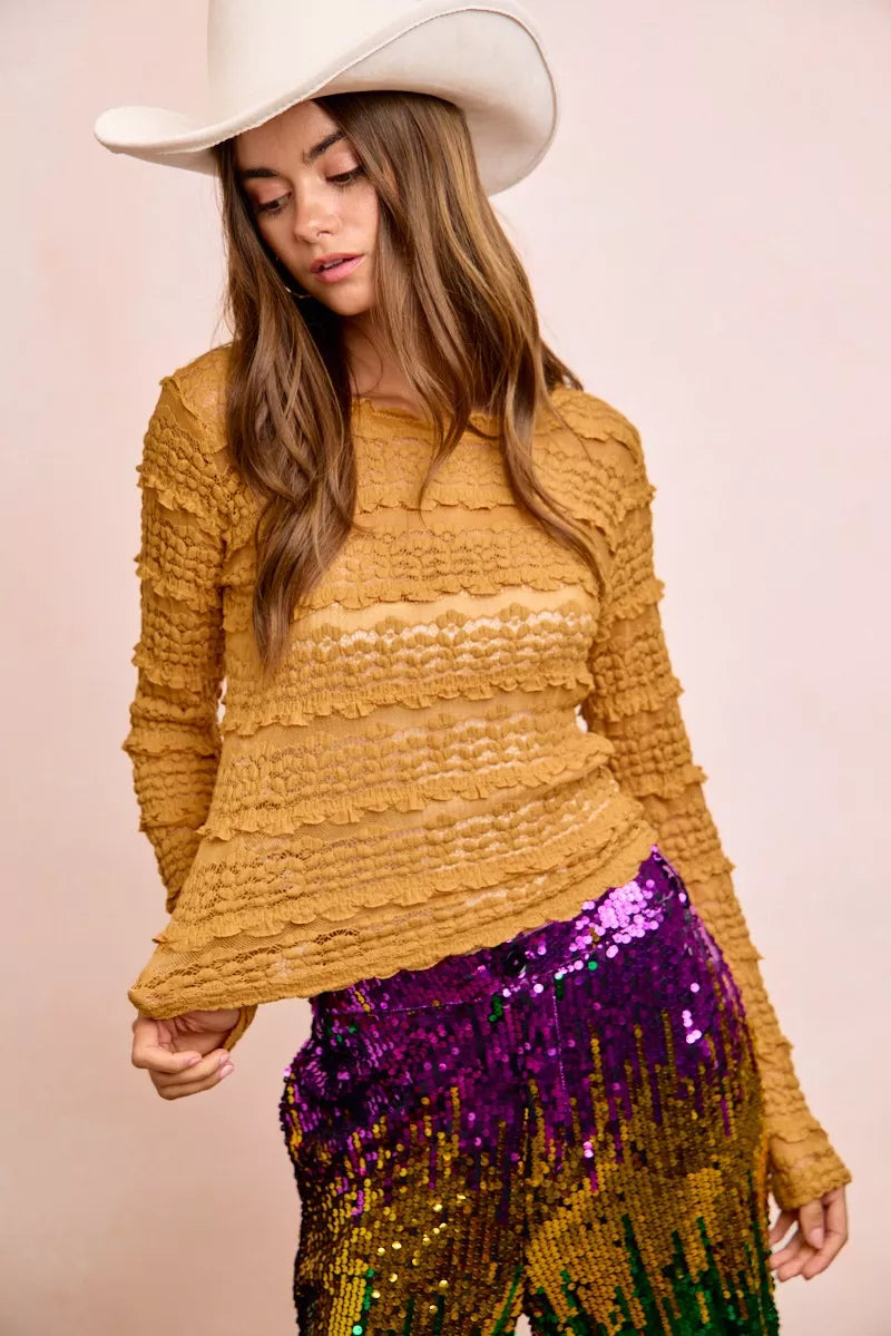 Mustard yellow textured sweater with ruffled sleeves and sequined pants