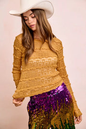 Mustard yellow textured sweater with ruffled sleeves and sequined pants