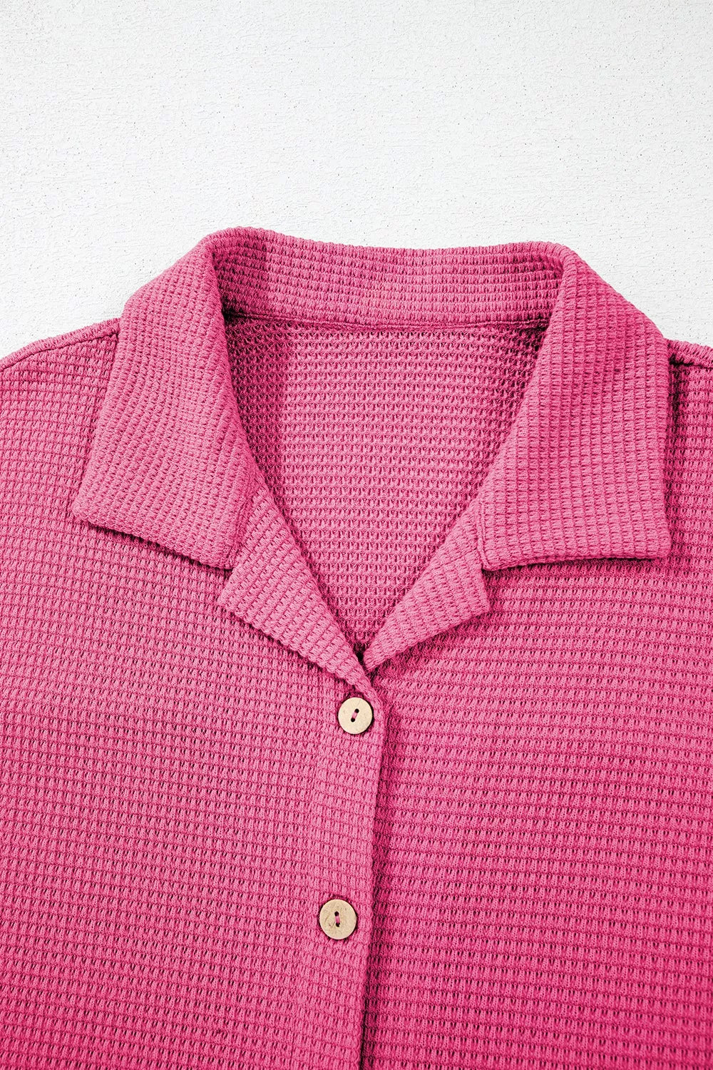 Vibrant pink waffle-knit polo shirt with wooden buttons in casual set