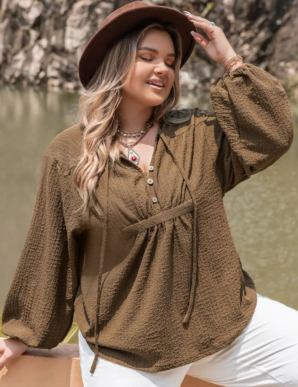 Plus size tie neck long sleeve blouse with brown texture, white pants, hat