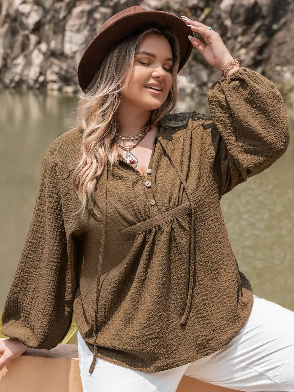 Plus size tie neck long sleeve blouse with brown texture, white pants, hat