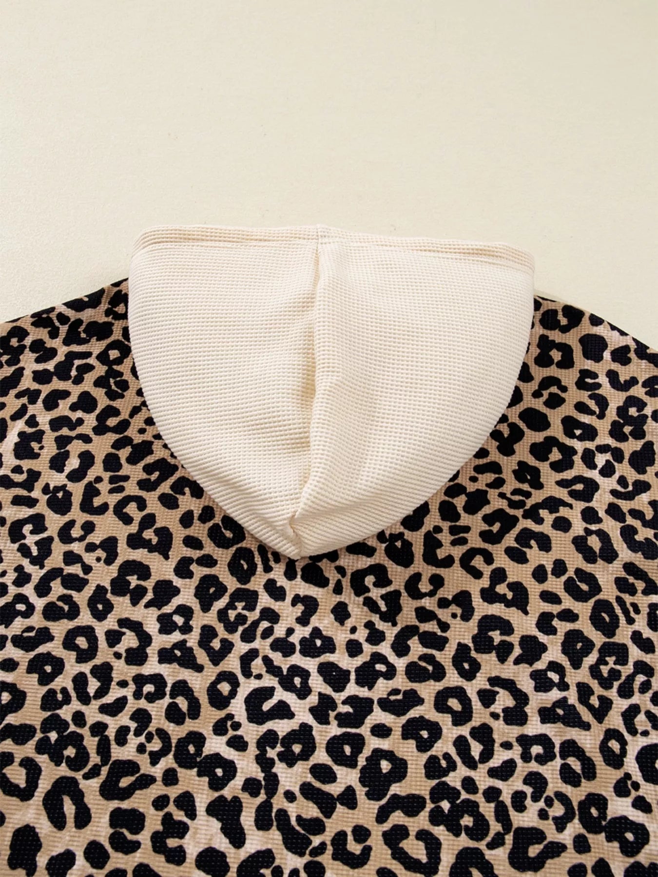 Leopard print long sleeve hoodie with cream hood lining, drawstring and pocket