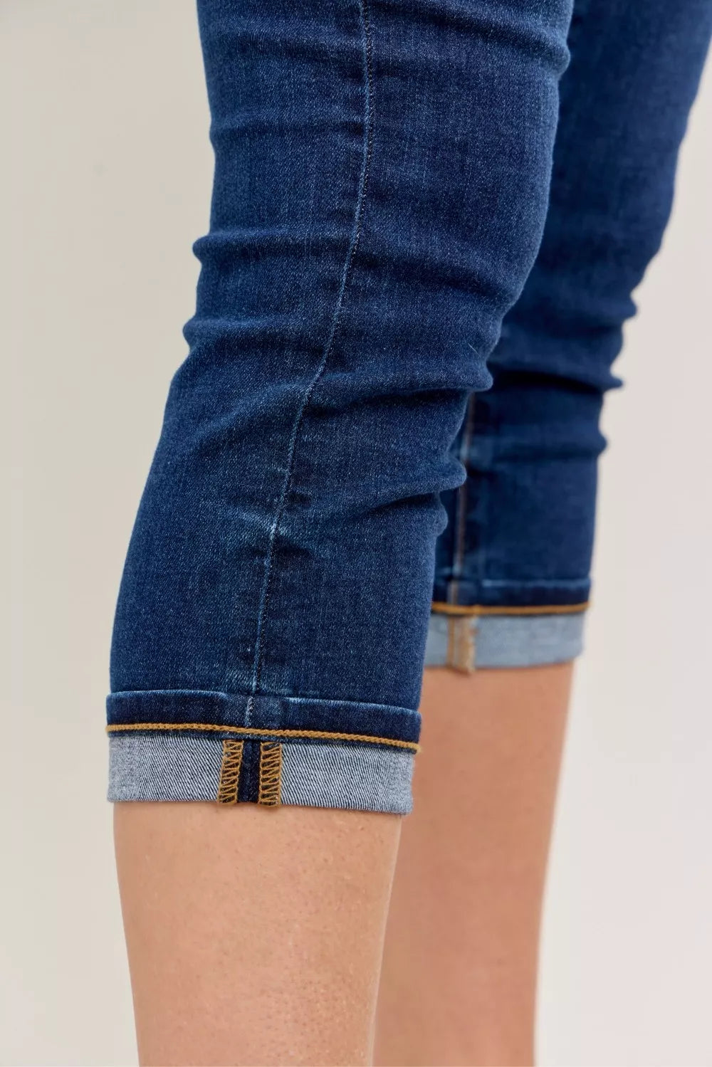Judy Blue high waist capri jeans in dark blue denim with rolled cuffs, tan stitching