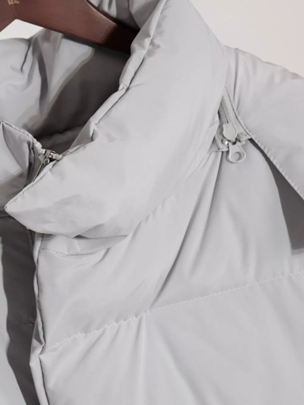 Light gray pocketed zip-up hooded puffer jacket with drawstring hood