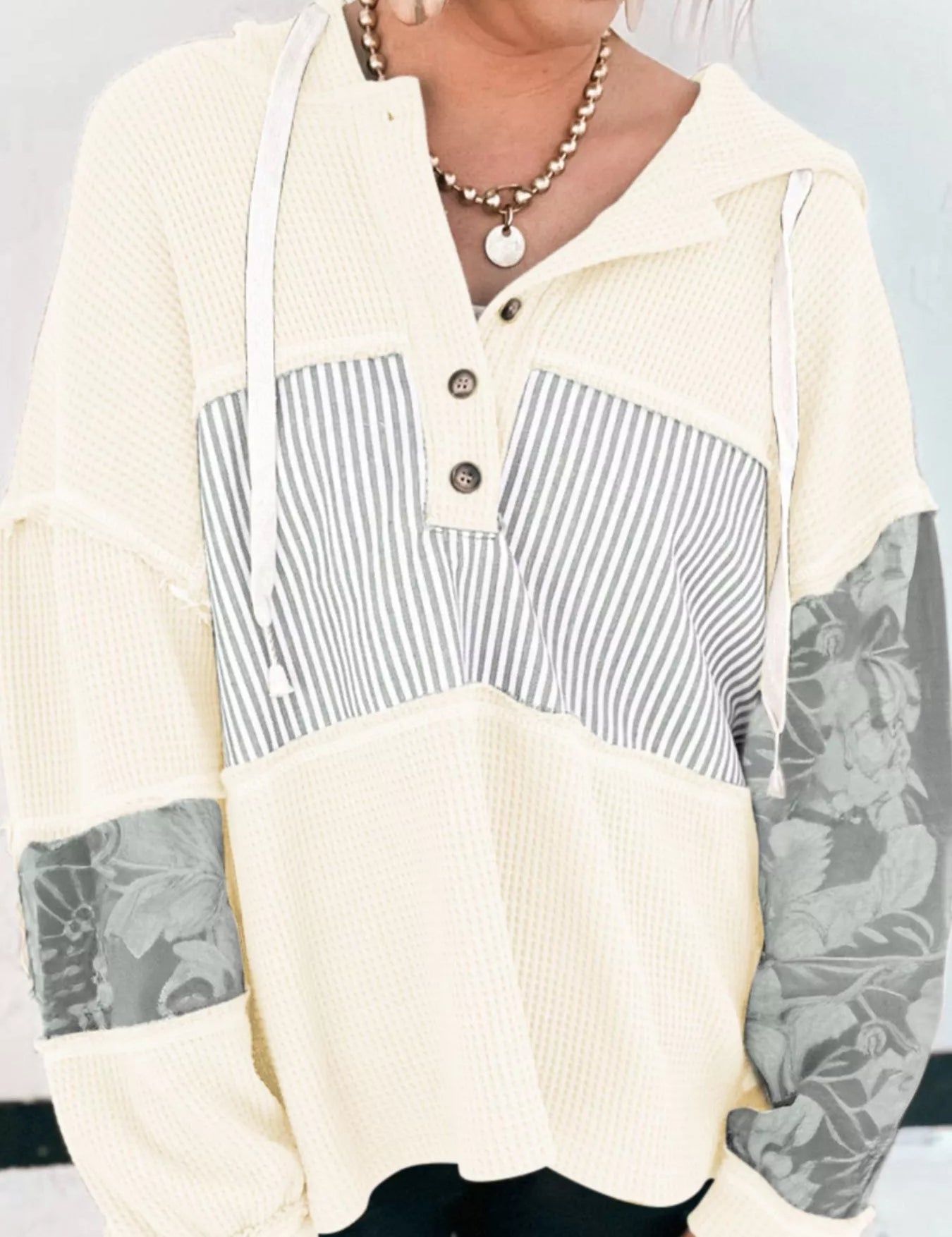 Cream and gray striped henley hoodie with floral sleeves and button front