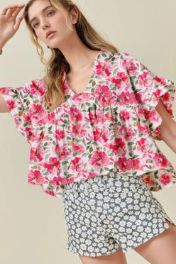 Pink floral boxy fit ruffled short sleeve blouse with v-neckline